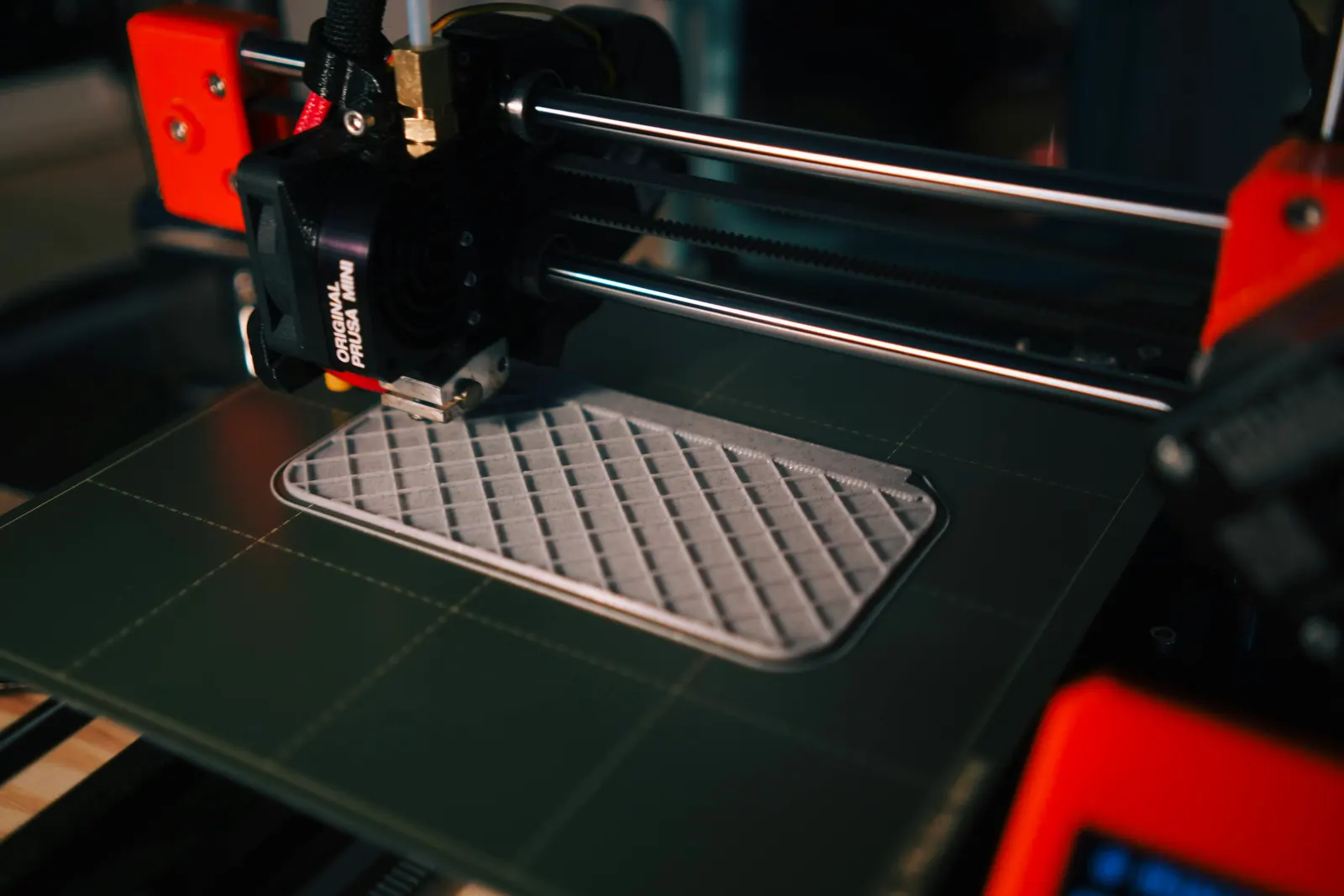 A printer laying filament onto a build plate